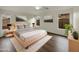 Cozy bedroom features neutral walls, modern furnishings, ceiling fan, and natural light from the windows at 42618 W Oakland Dr, Maricopa, AZ 85138