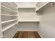 Walk-in closet with ample shelving, providing generous storage space at 42618 W Oakland Dr, Maricopa, AZ 85138