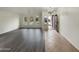 Open living area with tile and hard surface floors, neutral walls, a chandelier, and natural light from the arched windows at 42618 W Oakland Dr, Maricopa, AZ 85138