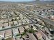 An aerial shot shows a community of single-Gathering homes with desert landscaping near roads and distant mountains at 4315 W Phalen Dr, New River, AZ 85087