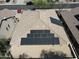 This aerial view showcases a roof equipped with solar panels, complemented by desert landscaping at 4315 W Phalen Dr, New River, AZ 85087