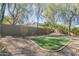 The beautiful landscaped backyard features an artificial turf area, mature shade trees, and desert plantings at 4315 W Phalen Dr, New River, AZ 85087