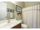 Bright bathroom featuring a vanity with sink, toilet, and a shower/tub combination with curtain at 4315 W Phalen Dr, New River, AZ 85087