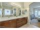 Bathroom featuring a double sink vanity leading into the bathroom at 4315 W Phalen Dr, New River, AZ 85087