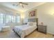 Bedroom with natural light, a ceiling fan, two bedside tables, and neutral colors at 4315 W Phalen Dr, New River, AZ 85087