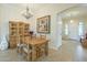 Bright dining room featuring chandelier, a wooden table with seating for four, and a hutch at 4315 W Phalen Dr, New River, AZ 85087