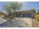 Attractive home with desert landscaping, a tiled roof, and a spacious two-car garage at 4315 W Phalen Dr, New River, AZ 85087