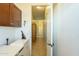 Functional hallway leading to laundry area with storage and shelving at 4315 W Phalen Dr, New River, AZ 85087