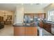 View of the open kitchen with granite countertops, stainless appliances, and dark wood cabinets at 4315 W Phalen Dr, New River, AZ 85087