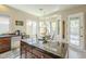 Granite kitchen island with a breakfast bar that flows into the dining area at 4315 W Phalen Dr, New River, AZ 85087