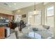 The open kitchen and breakfast nook with natural light. Stainless steel appliances and dark cabinetry at 4315 W Phalen Dr, New River, AZ 85087