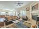 Inviting living room with a cozy fireplace, ceiling fan, and an open floorplan at 4315 W Phalen Dr, New River, AZ 85087