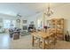 A well-lit living room and dining room including a fireplace, TV, hutch, and dining table at 4315 W Phalen Dr, New River, AZ 85087