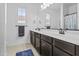 Bathroom featuring a dual sink vanity, a plush rug, and white walls, offering a clean and modern aesthetic at 4321 E Zion Way, Chandler, AZ 85249