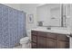 Cozy bathroom with dark wood cabinets, stylish mirror, and patterned shower curtain at 4321 E Zion Way, Chandler, AZ 85249