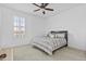 Bright bedroom with neutral tones, a comfy bed, carpeted floors, shuttered window, and a ceiling fan at 4321 E Zion Way, Chandler, AZ 85249