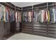 Walk-in closet provides plenty of storage with custom shelving, drawers, and ample hanging space at 4321 E Zion Way, Chandler, AZ 85249