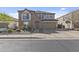 Two-story home featuring a stone facade, two-car garage and a small balcony at 4321 E Zion Way, Chandler, AZ 85249