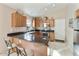 Cozy kitchen with breakfast bar seating, granite countertops, and stainless appliances at 43870 W Baker Dr, Maricopa, AZ 85138