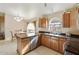 Bright kitchen area featuring stainless steel appliances, granite countertops, and dining area at 43870 W Baker Dr, Maricopa, AZ 85138