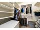 Well organized walk-in closet with built in shelving for maximum storage at 43870 W Baker Dr, Maricopa, AZ 85138