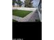Well-maintained backyard with artificial grass, a brick border, and a white picket fence at 4606 E Cheyenne Dr, Phoenix, AZ 85044