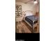Cozy bedroom with wood-look floors and a decorative metal headboard at 4606 E Cheyenne Dr, Phoenix, AZ 85044