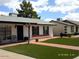 Well-kept single-story home featuring green artificial grass and a red brick walkway at 4606 E Cheyenne Dr, Phoenix, AZ 85044