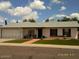 Charming single-story home with a well-maintained front yard and white garage door at 4606 E Cheyenne Dr, Phoenix, AZ 85044