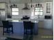Stylish kitchen featuring modern lighting, a subway tile backsplash, and a central island at 4606 E Cheyenne Dr, Phoenix, AZ 85044