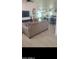 Open-concept living space with neutral tones and tile flooring, seamlessly connecting the kitchen at 4606 E Cheyenne Dr, Phoenix, AZ 85044