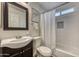 A bright bathroom featuring modern subway tiles, stylish vanity, and a shower with bathtub at 4826 W Michigan Ave, Glendale, AZ 85308