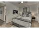 Cozy bedroom featuring modern decor, a mounted television, and wood flooring with a stylish rug at 4826 W Michigan Ave, Glendale, AZ 85308