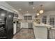 Well-lit kitchen featuring white cabinetry, stainless steel appliances, and a breakfast bar with comfortable seating at 4826 W Michigan Ave, Glendale, AZ 85308