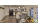 A modern kitchen featuring stainless steel appliances, an island with bar seating, and unique backsplash at 4826 W Michigan Ave, Glendale, AZ 85308