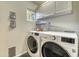 Functional laundry room with modern washer and dryer units, upper cabinets, and natural light at 4826 W Michigan Ave, Glendale, AZ 85308