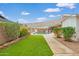 Spacious backyard with a pool, artificial turf, and a shade canopy for outdoor enjoyment at 4901 N 85Th St, Scottsdale, AZ 85251