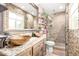 Stylish bathroom featuring stone accents, dual vessel sinks, and a glass-enclosed shower at 4901 N 85Th St, Scottsdale, AZ 85251