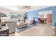 Spacious living room with blue accent wall, tile flooring, and seamless flow into the dining area at 4901 N 85Th St, Scottsdale, AZ 85251