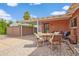 Charming outdoor patio area with comfortable seating, a brick wall, and a covered carport at 4901 N 85Th St, Scottsdale, AZ 85251