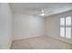 Cozy bedroom featuring neutral carpet, a ceiling fan, and plantation shutters at 5102 N 31St Pl # 436, Phoenix, AZ 85016