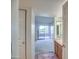 Bright hallway with tile accents leading to a carpeted living area and well-lit bathroom at 5102 N 31St Pl # 436, Phoenix, AZ 85016