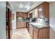 Well-lit kitchen featuring granite counters, wood cabinets, and red tiled floors at 5102 N 31St Pl # 436, Phoenix, AZ 85016