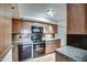 Updated kitchen featuring modern black appliances, granite countertops, and tiled floors at 5102 N 31St Pl # 436, Phoenix, AZ 85016