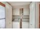 Bright laundry room featuring white appliances, tiled floors, and storage at 5102 N 31St Pl # 436, Phoenix, AZ 85016