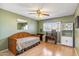 Cozy bedroom with light wood floors, a ceiling fan, and a large window for natural light at 5255 W Caribbean Ln, Glendale, AZ 85306