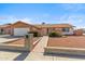 Charming single-story home with a two-car garage, landscaped yard, and inviting brick pathway at 5255 W Caribbean Ln, Glendale, AZ 85306