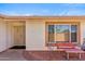 Inviting front entrance with a secure screen door, tiled patio, and seating area at 5255 W Caribbean Ln, Glendale, AZ 85306