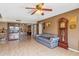 Comfortable living room with a ceiling fan, hutch, and view to other rooms at 5255 W Caribbean Ln, Glendale, AZ 85306