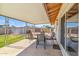 Relaxing covered patio with outdoor dining set and barbecue, ideal for enjoying backyard views at 5255 W Caribbean Ln, Glendale, AZ 85306